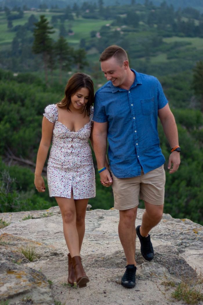 Walking hand in hand across the rocks at the overlook