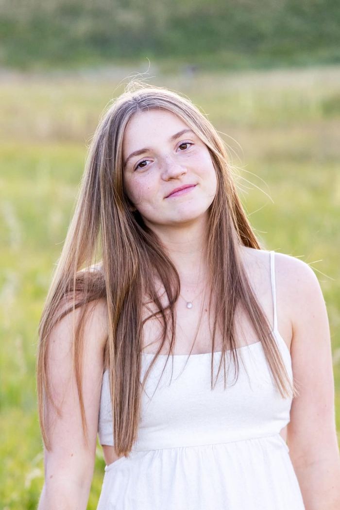 Soft close-up senior portrait in a white dress