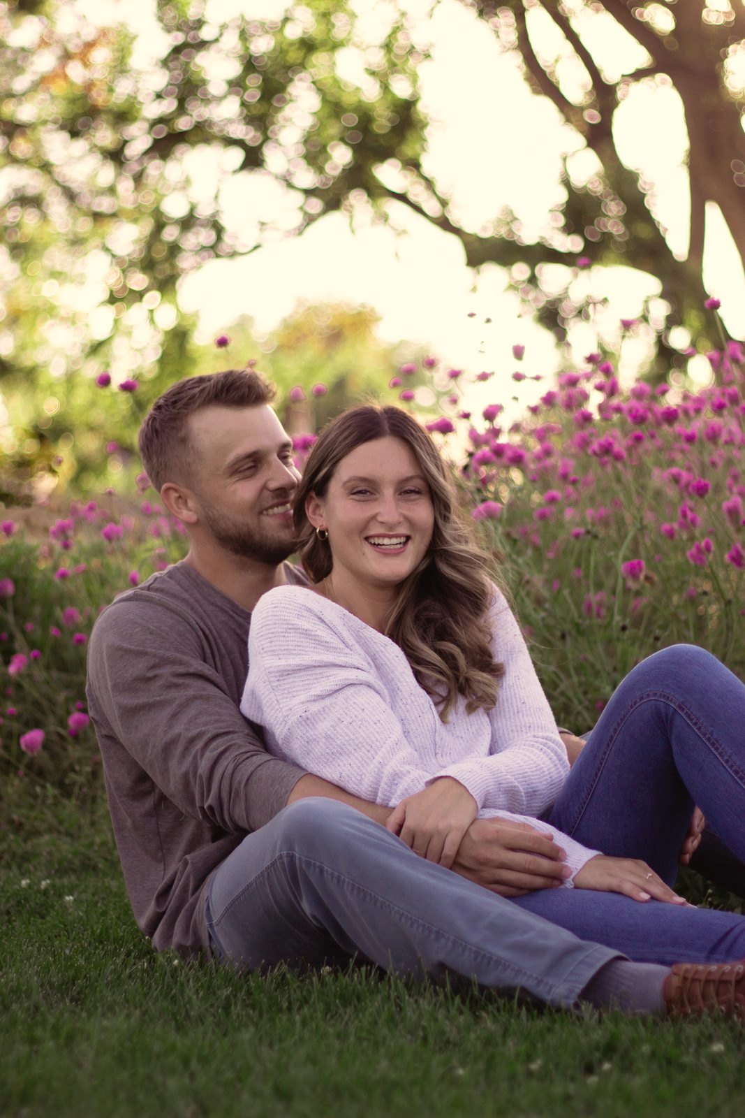 Couple laughing in a field of flowers