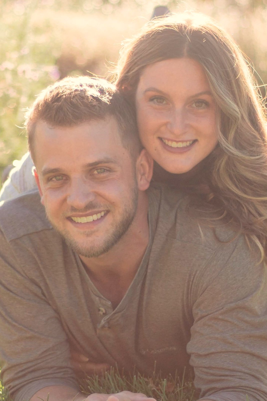 Couple laughing together in the grass