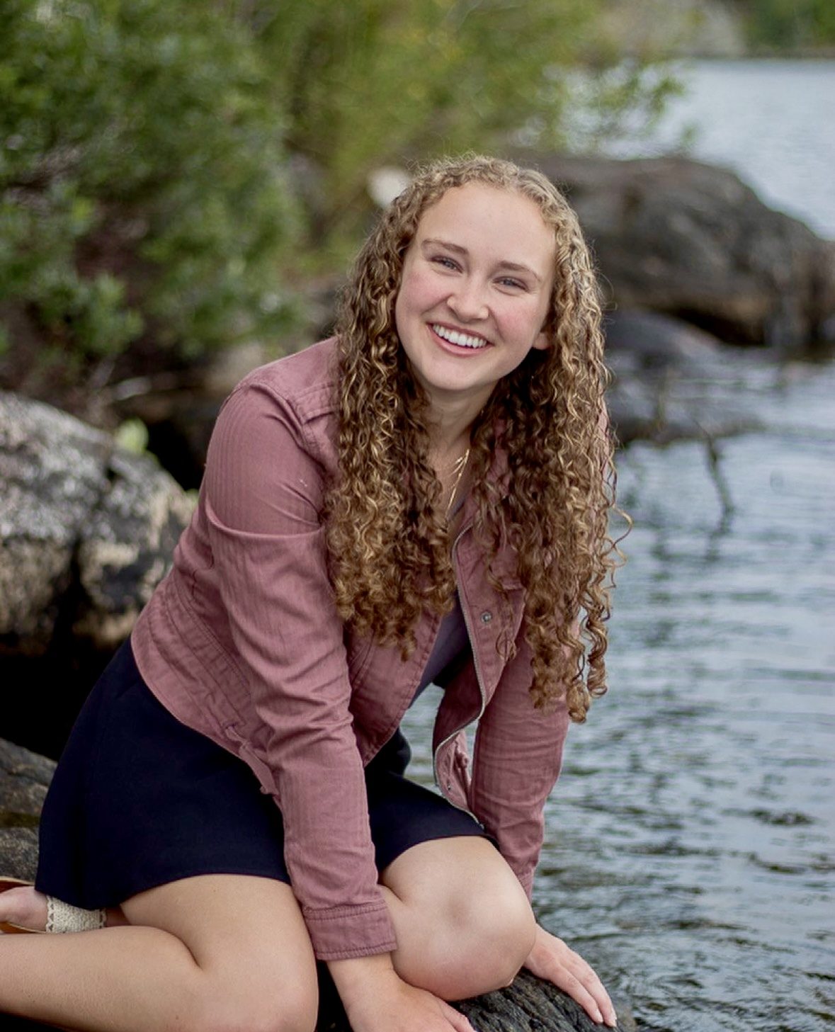 Senior portrait by a mountain lake