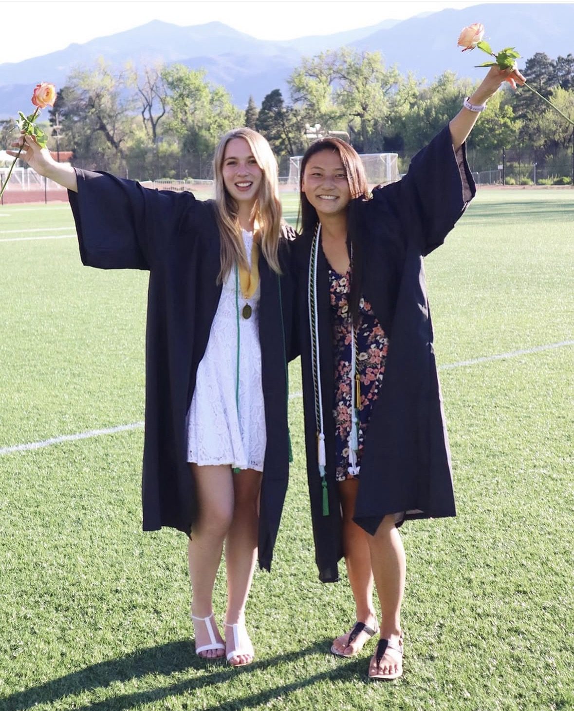 Two Colorado graduates celebrating with roses