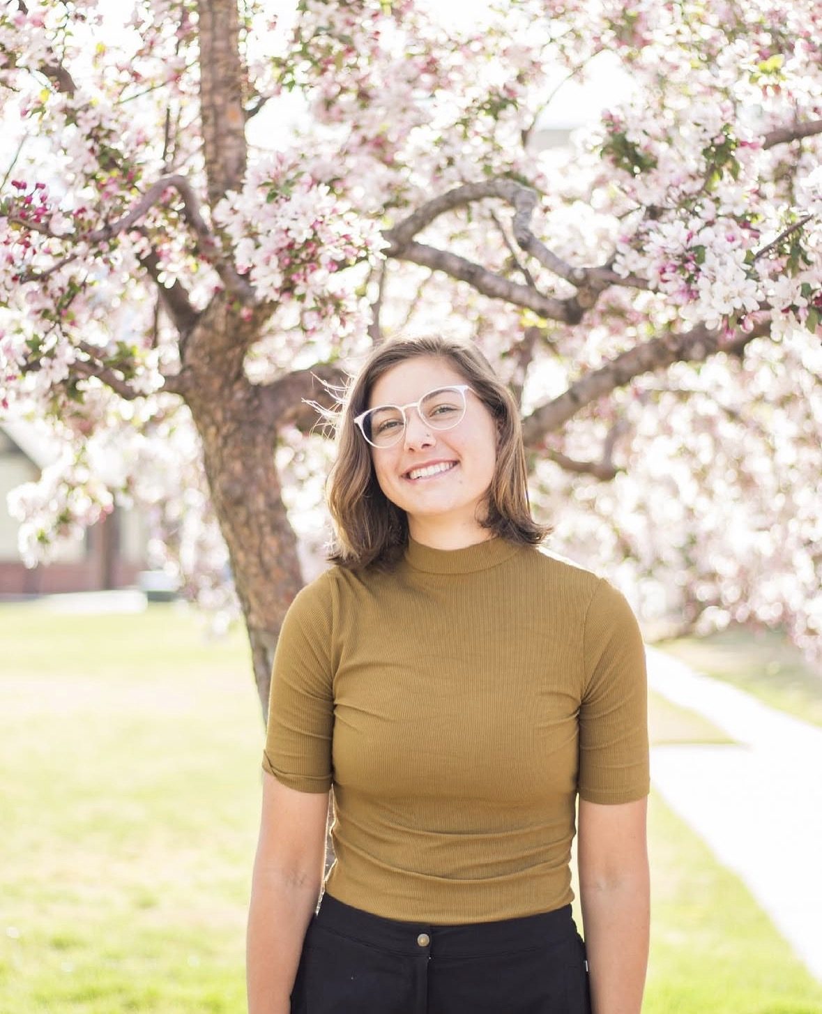 Senior portrait under a blossoming spring tree