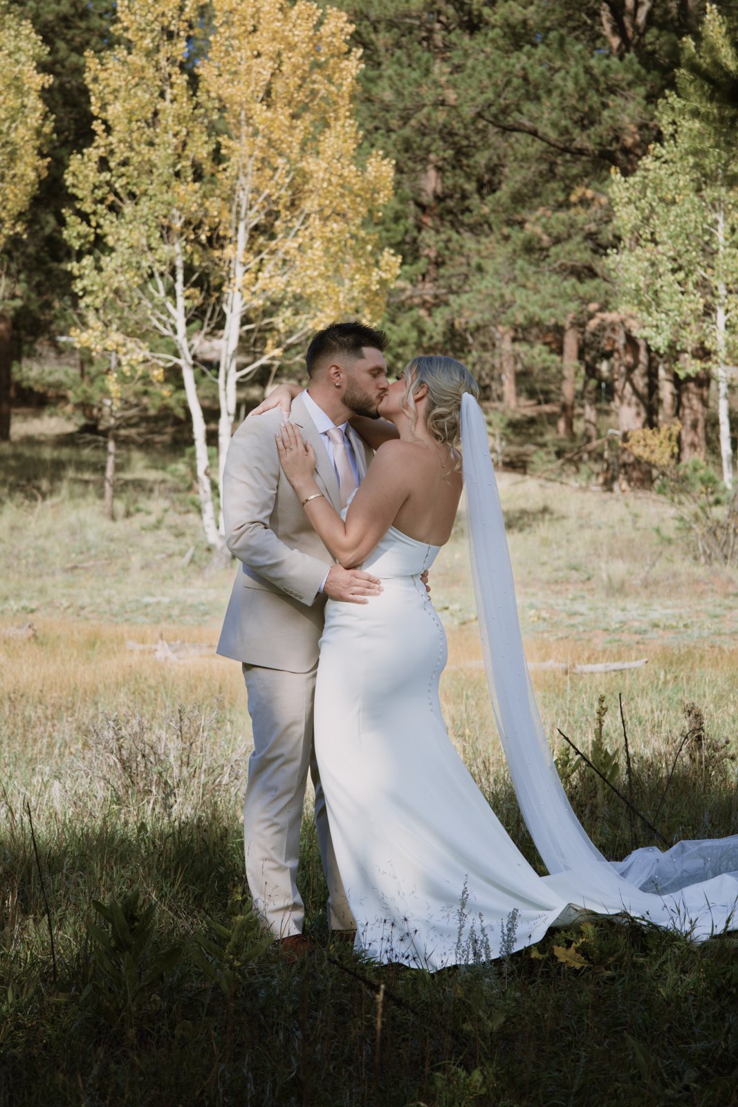 Couple kissing among the aspens