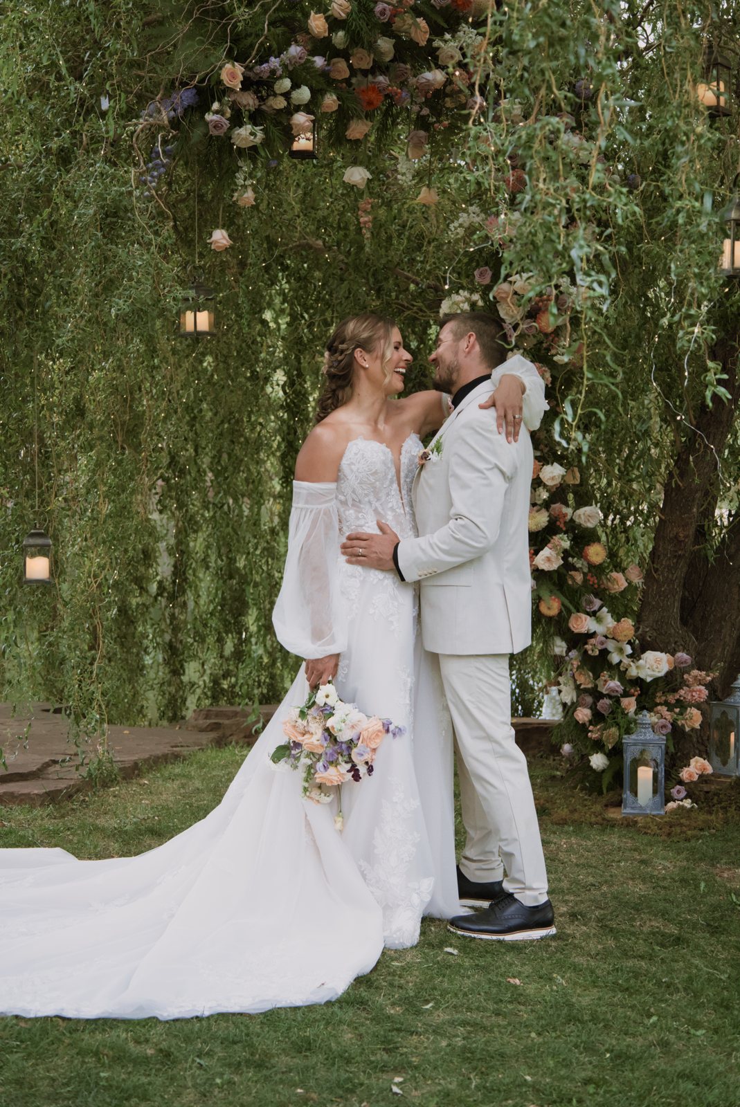 Couple embracing under the willow arch